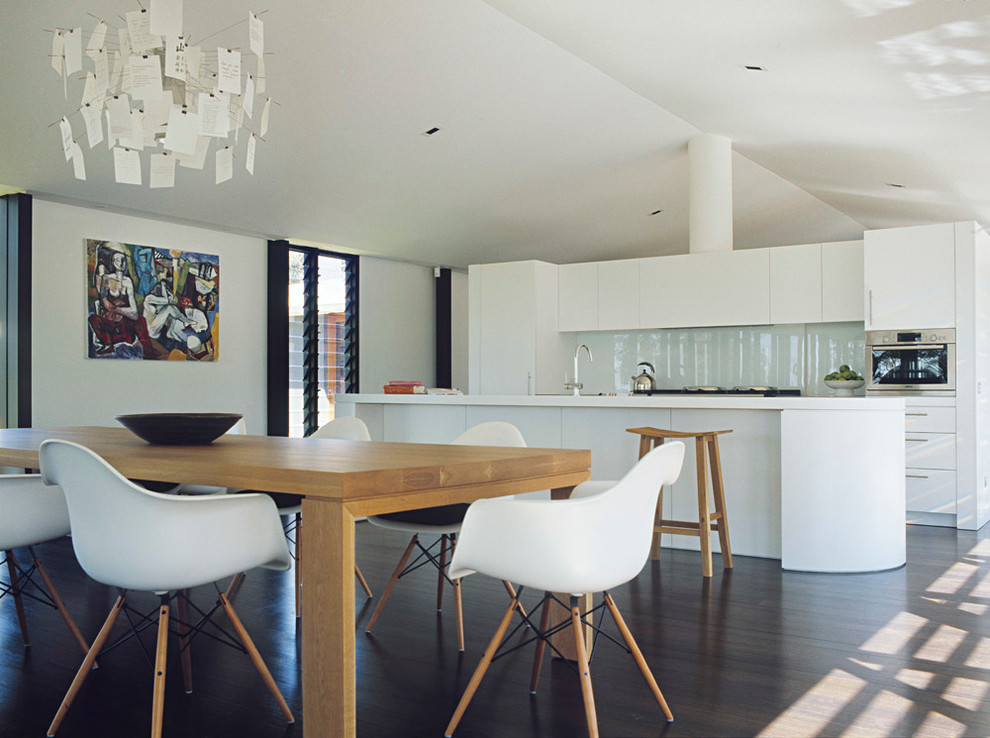 This is an example of a large contemporary open plan dining in Melbourne with dark hardwood floors.