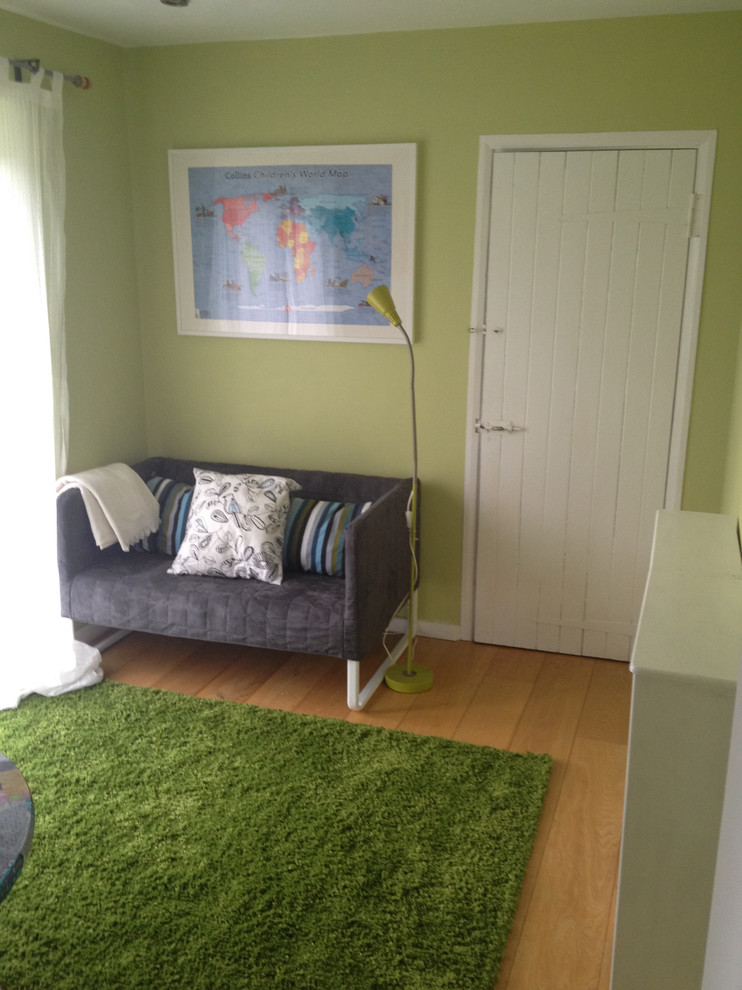 Kids' room - small contemporary gender-neutral medium tone wood floor kids' room idea with multicolored walls