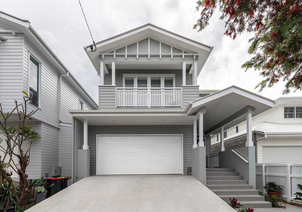 Mid-sized transitional two-storey grey house exterior in Brisbane with vinyl siding and a gable roof.
