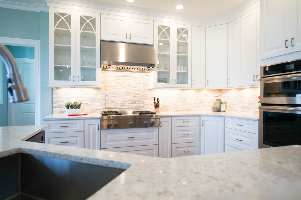 Example of a transitional l-shaped medium tone wood floor eat-in kitchen design in Boston with white cabinets, granite countertops, gray backsplash, stainless steel appliances and an island