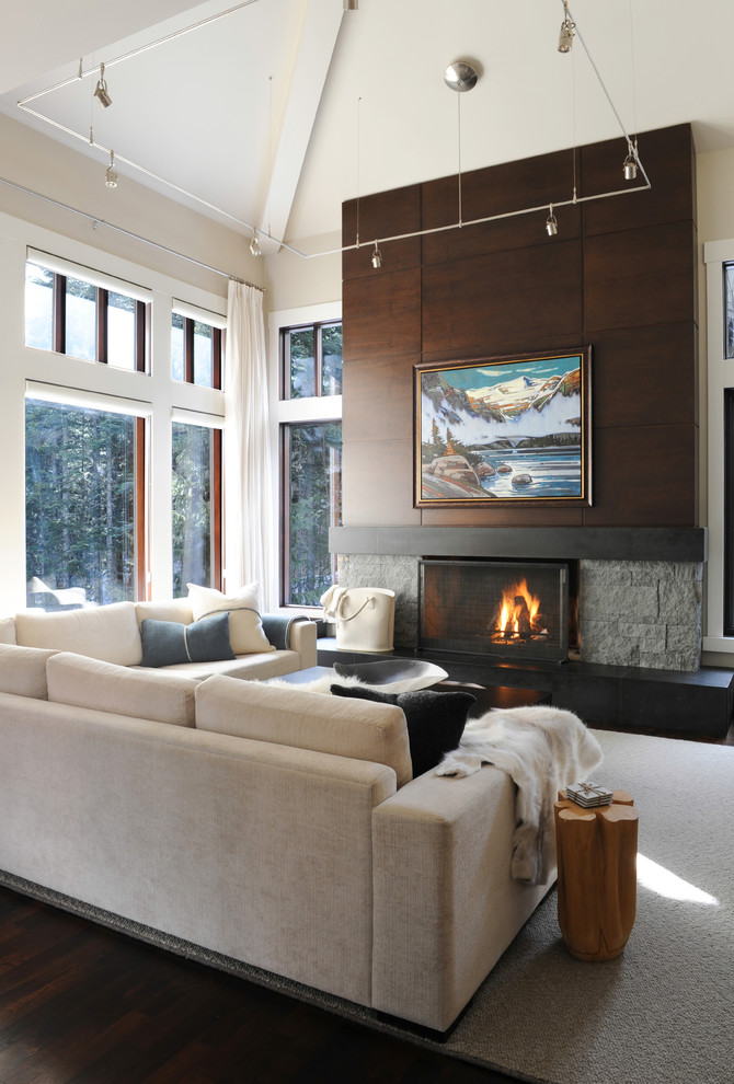 This is an example of a large contemporary open concept living room in Vancouver with white walls, a stone fireplace surround, dark hardwood floors, a standard fireplace and no tv.