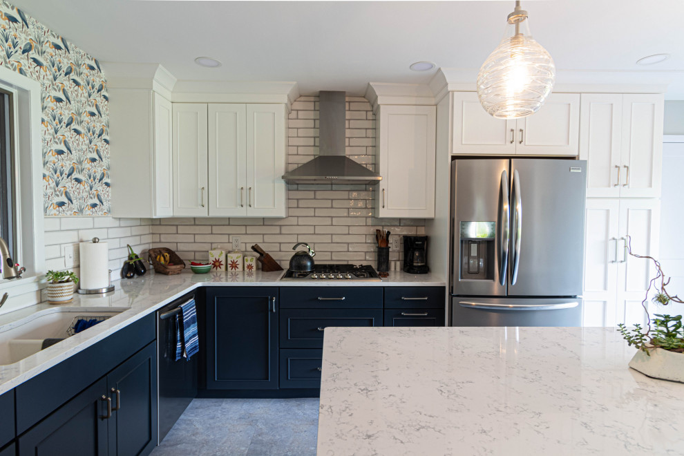 Mid-sized transitional l-shaped porcelain tile and gray floor eat-in kitchen photo with an undermount sink, flat-panel cabinets, white cabinets, quartz countertops, white backsplash, subway tile backsplash, stainless steel appliances, an island and white countertops