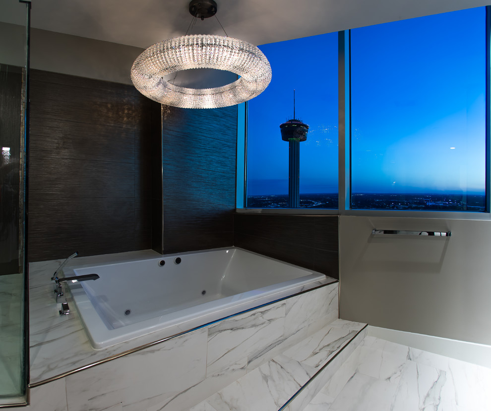 Design ideas for a mid-sized contemporary master bathroom in Austin with flat-panel cabinets, medium wood cabinets, a drop-in tub, a corner shower, a bidet, white tile, marble, grey walls, porcelain floors, an undermount sink, engineered quartz benchtops, white floor and a hinged shower door.