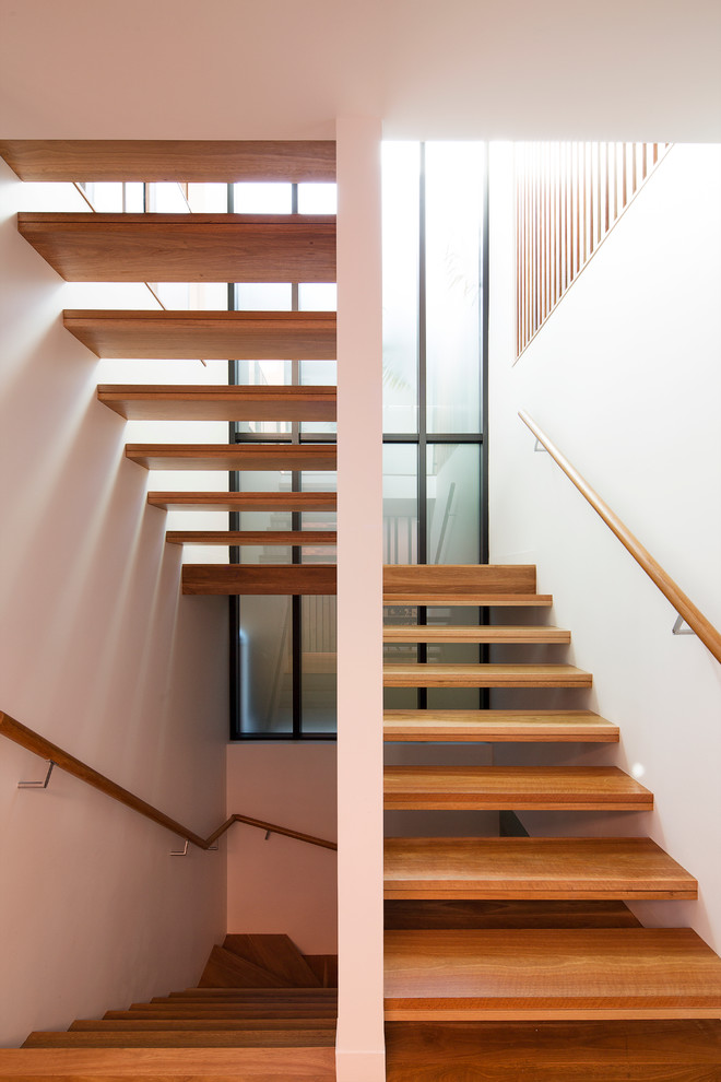 Mid-sized contemporary wood u-shaped staircase in Sydney with open risers.