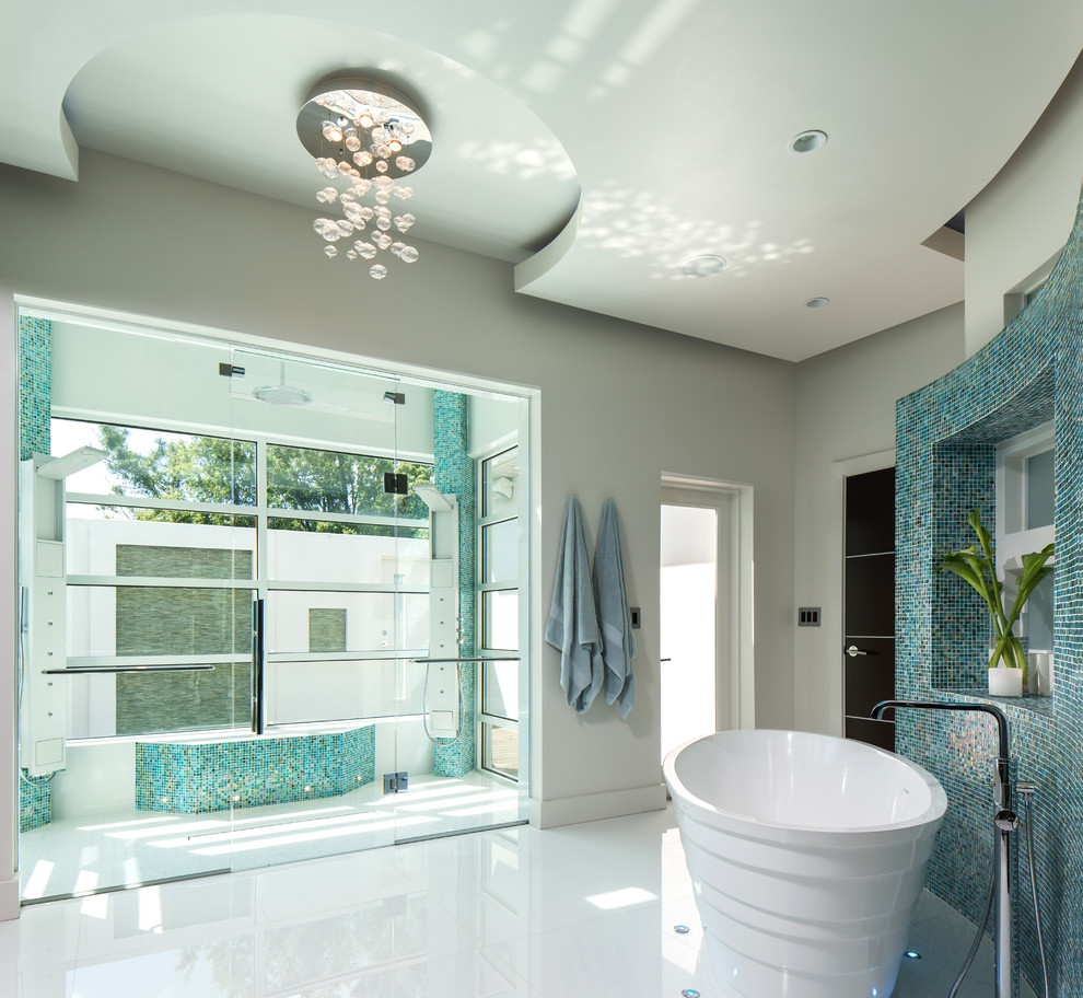 Photo of a contemporary master bathroom in Orlando with a freestanding tub, a curbless shower, multi-coloured tile and mosaic tile.