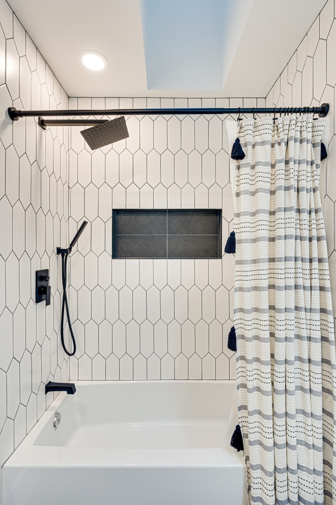 Inspiration for a small modern bathroom in DC Metro with a drop-in tub, an alcove shower, white tile, white walls, ceramic floors, black floor, a shower curtain and white benchtops.