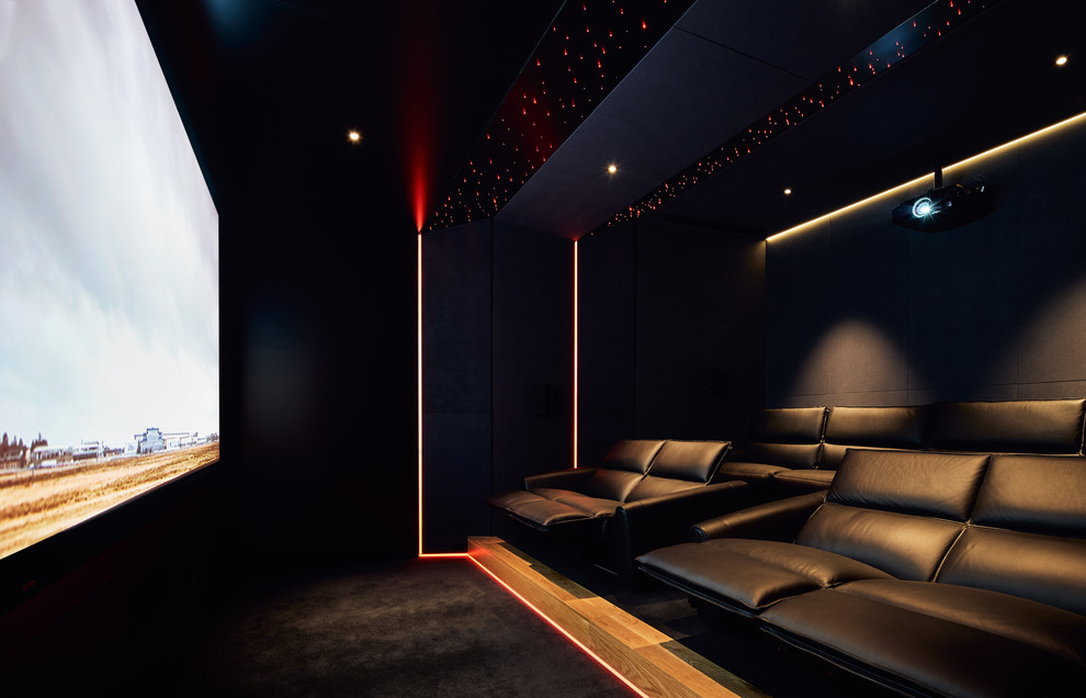 Mid-sized contemporary enclosed home theatre in Melbourne with black walls, carpet, a projector screen and black floor.
