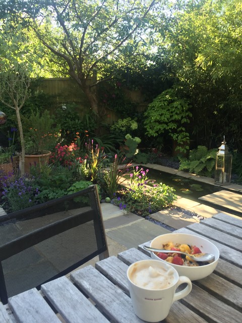 Small garden designed for relaxing with large pond and lots of planting contemporary-garden