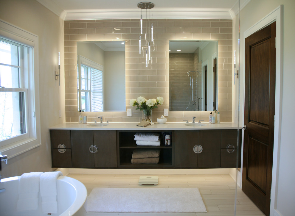 Design ideas for a mid-sized transitional master bathroom in Milwaukee with flat-panel cabinets, dark wood cabinets, a freestanding tub, a double shower, a one-piece toilet, brown tile, ceramic tile, beige walls, ceramic floors, an undermount sink, engineered quartz benchtops, beige floor, an open shower, white benchtops, an enclosed toilet, a double vanity and a floating vanity.