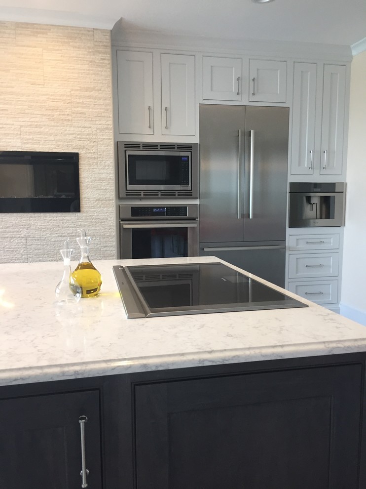 Inspiration for a large transitional ceramic tile and multicolored floor kitchen remodel with a farmhouse sink, beaded inset cabinets, white cabinets, quartz countertops, metallic backsplash, ceramic backsplash, stainless steel appliances and an island
