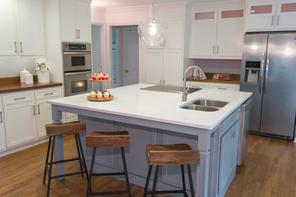 This is an example of a large contemporary l-shaped eat-in kitchen in Atlanta with an undermount sink, shaker cabinets, white cabinets, quartz benchtops, with island and multi-coloured benchtop.