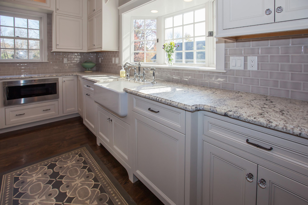 Design ideas for a mid-sized traditional u-shaped eat-in kitchen in Boston with a farmhouse sink, beaded inset cabinets, white cabinets, wood benchtops, beige splashback, cement tile splashback, stainless steel appliances, dark hardwood floors and with island.
