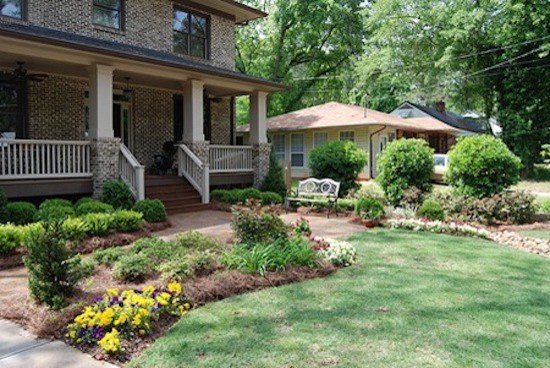 Inspiration for a front yard brick landscaping.