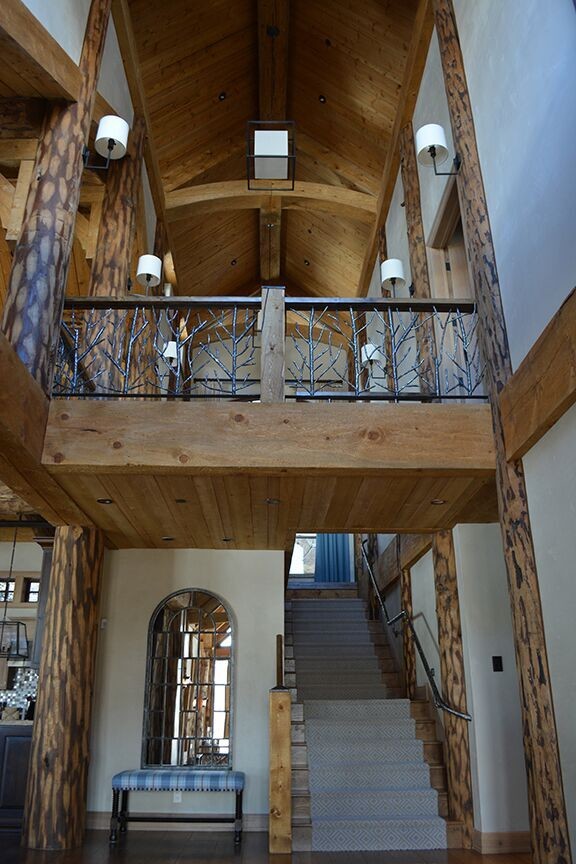 Mid-sized mountain style dark wood floor foyer photo in Denver with beige walls and a light wood front door
