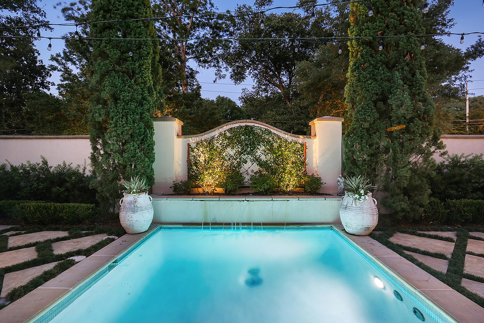 This is an example of a small mediterranean courtyard pool in New Orleans with concrete pavers.