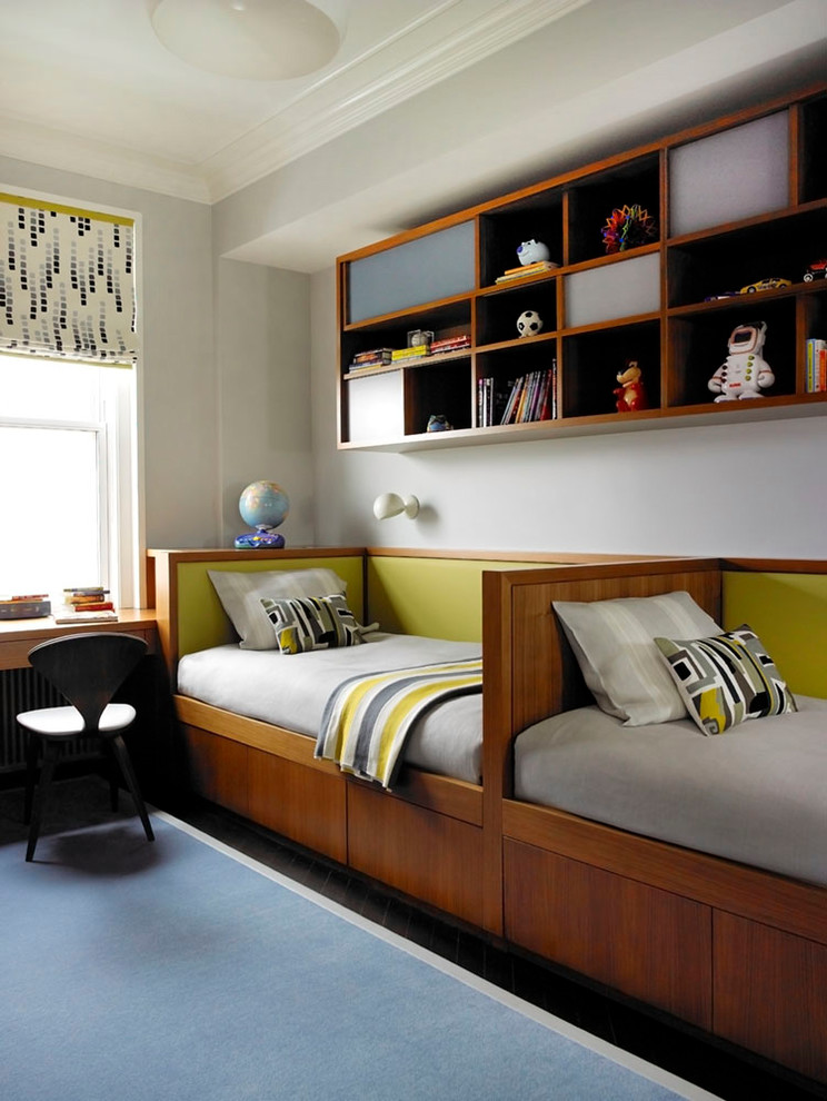 This is an example of a contemporary kids' room for boys in New York with grey walls and dark hardwood floors.