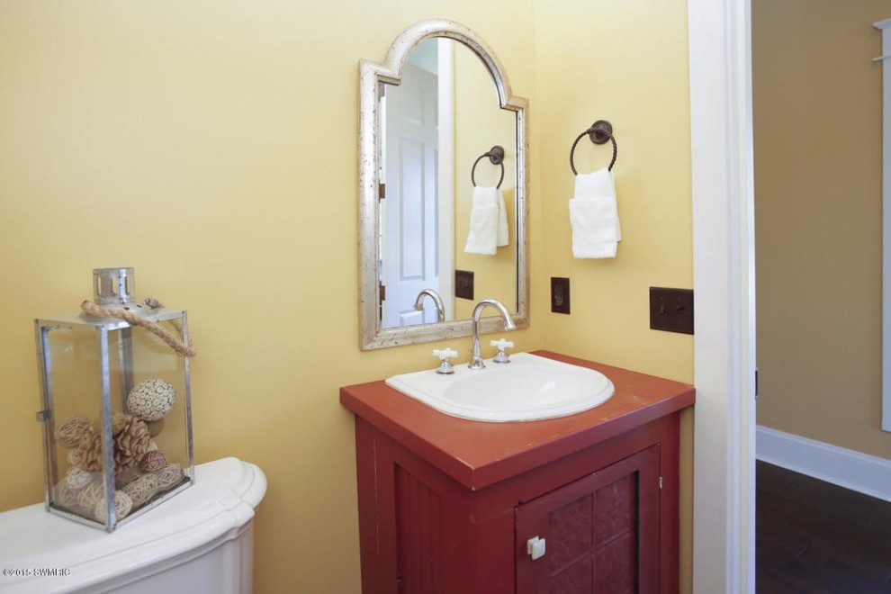 Design ideas for a mid-sized traditional 3/4 bathroom in Grand Rapids with a drop-in sink, wood benchtops, yellow walls, dark hardwood floors, shaker cabinets and red cabinets.