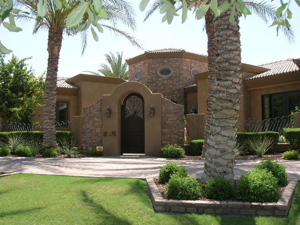 Inspiration for a large mediterranean one-storey stucco brown exterior in Phoenix with a hip roof.