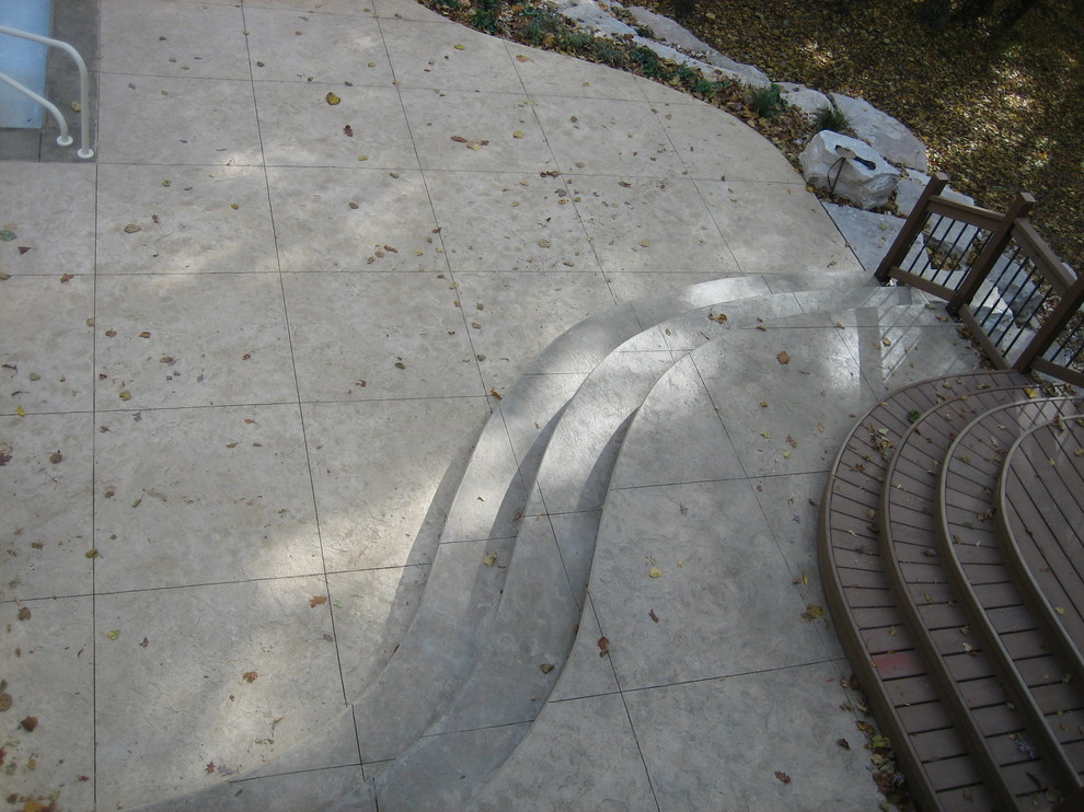 Large transitional backyard concrete paver and rectangular natural pool house photo in Cedar Rapids