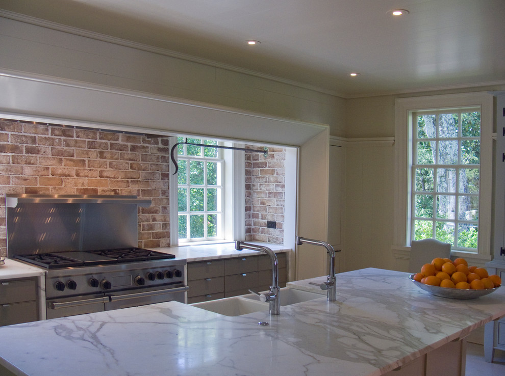 Mid-sized transitional single-wall kitchen photo in Charlotte with a farmhouse sink, flat-panel cabinets, white cabinets, marble countertops, stainless steel appliances and an island