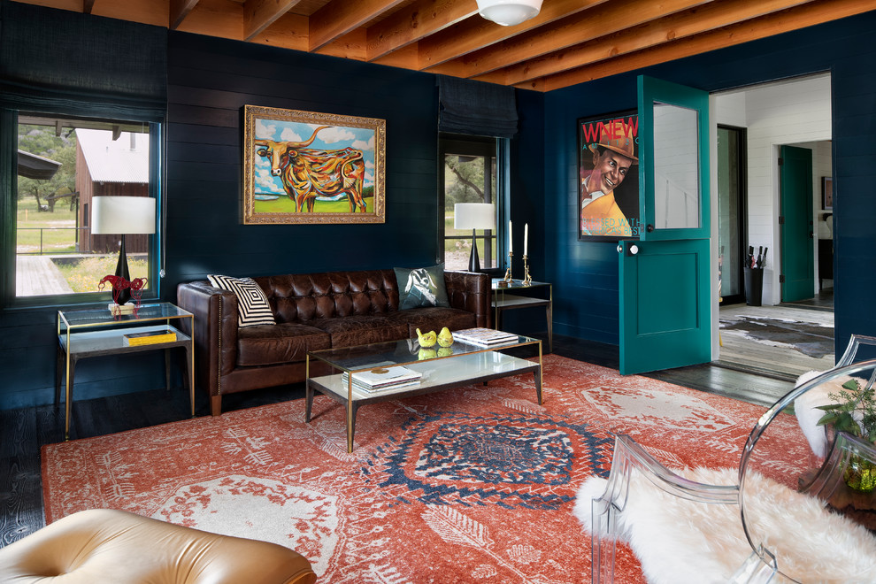 Design ideas for a country enclosed living room in Austin with blue walls, dark hardwood floors and no fireplace.