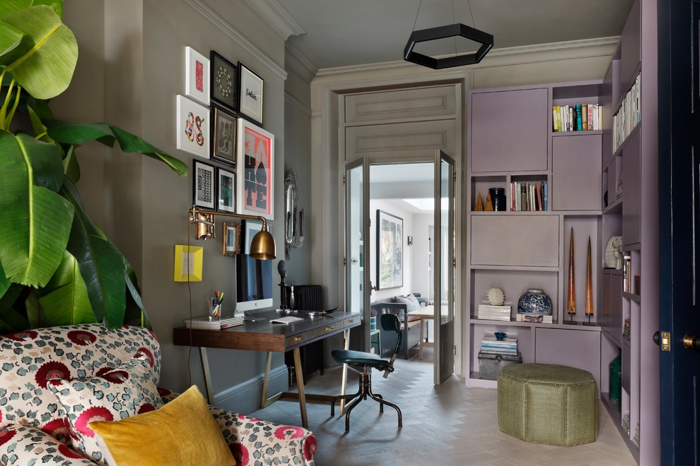 Design ideas for a small eclectic study room in London with grey walls, light hardwood floors and a freestanding desk.