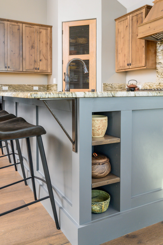 Inspiration for a transitional l-shaped eat-in kitchen remodel with an undermount sink, shaker cabinets, medium tone wood cabinets, multicolored backsplash, stone slab backsplash, stainless steel appliances, an island and multicolored countertops