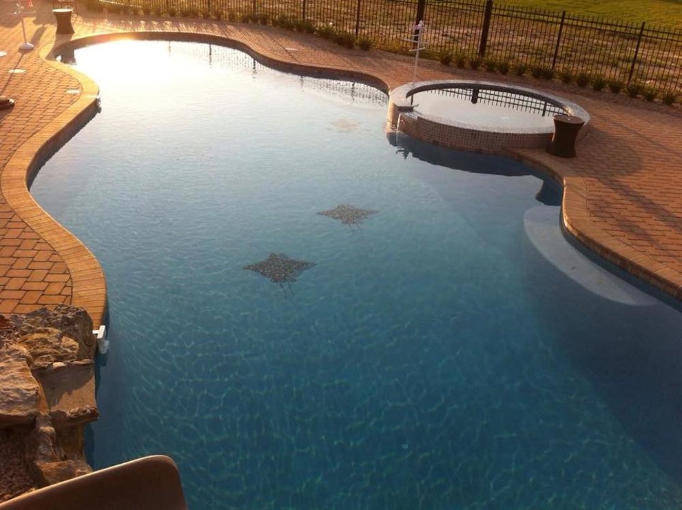 Inspiration for a large backyard custom-shaped natural hot tub remodel in New York