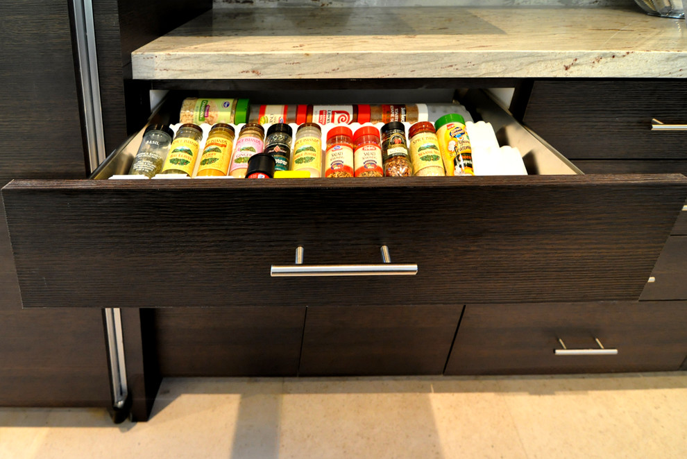 Eat-in kitchen - huge modern l-shaped ceramic tile eat-in kitchen idea in Other with an undermount sink, flat-panel cabinets, black cabinets, solid surface countertops, multicolored backsplash, stone slab backsplash, stainless steel appliances and an island