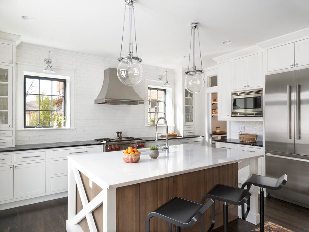 Mid-sized transitional l-shaped dark wood floor kitchen photo in Denver with an undermount sink, recessed-panel cabinets, white cabinets, white backsplash, stainless steel appliances and an island
