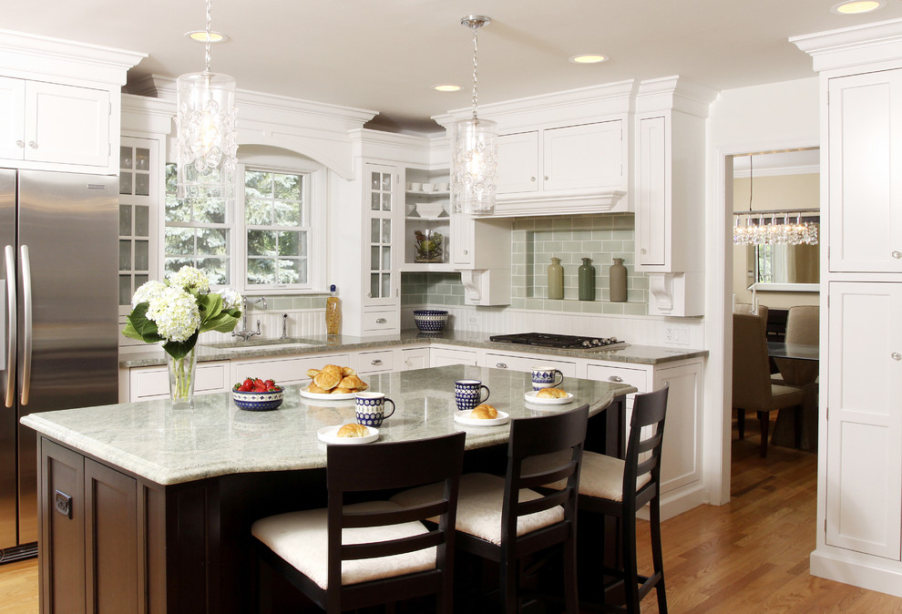 Inspiration for a large traditional l-shaped separate kitchen in Chicago with an undermount sink, shaker cabinets, white cabinets, granite benchtops, green splashback, subway tile splashback, stainless steel appliances, with island and medium hardwood floors.