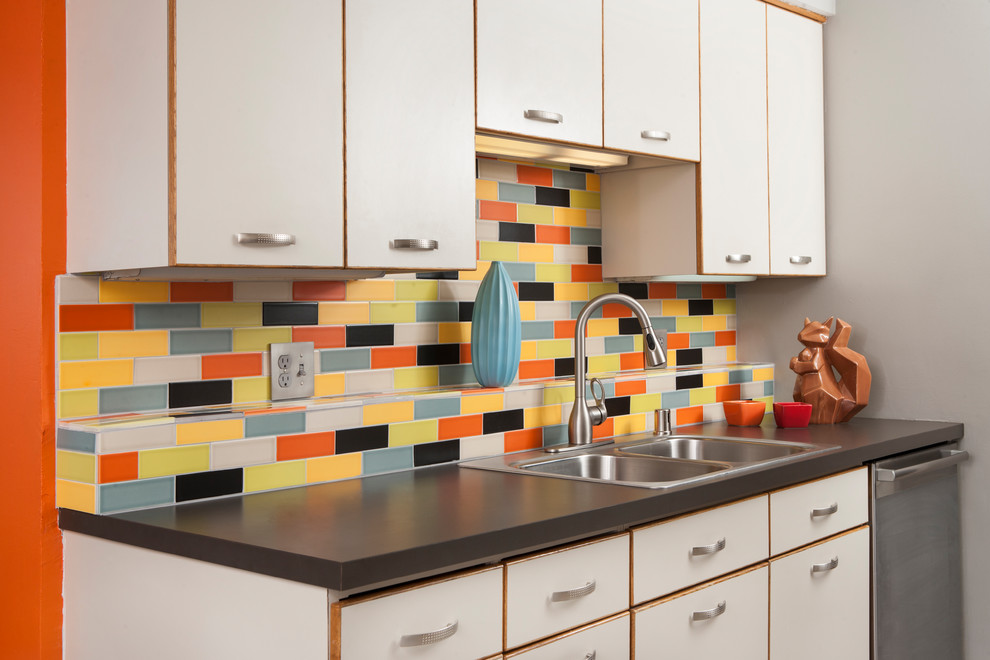 Inspiration for a mid-sized midcentury galley separate kitchen in Minneapolis with a drop-in sink, white cabinets, laminate benchtops, multi-coloured splashback, ceramic splashback, white appliances and no island.