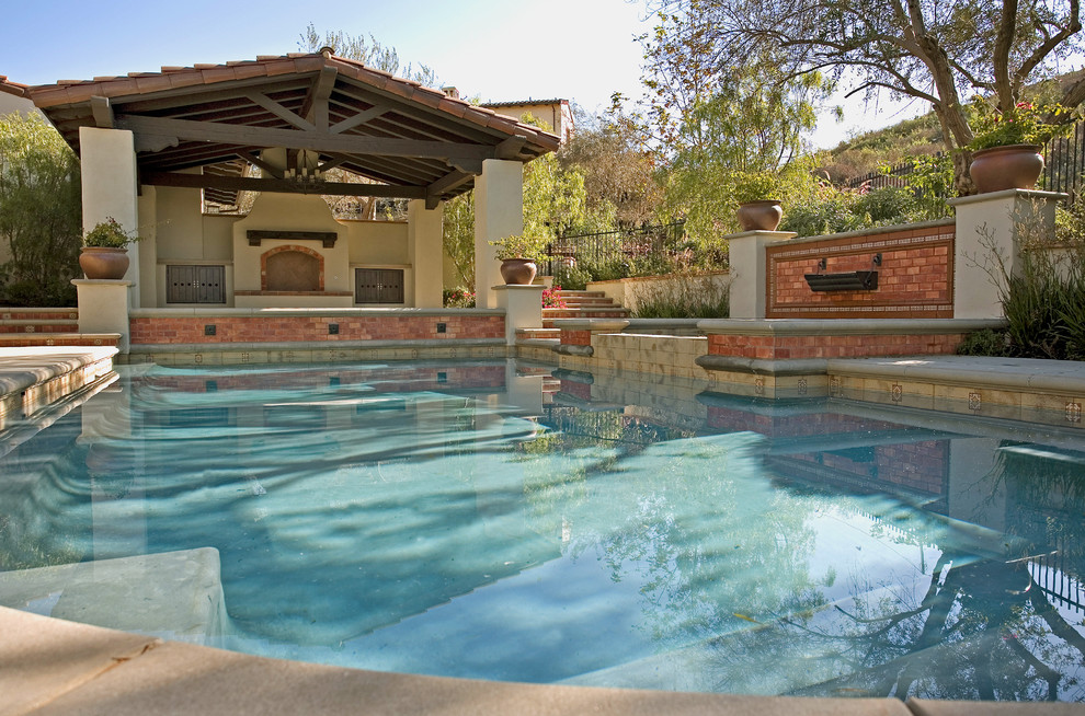 Design ideas for a mediterranean custom-shaped pool in Los Angeles.