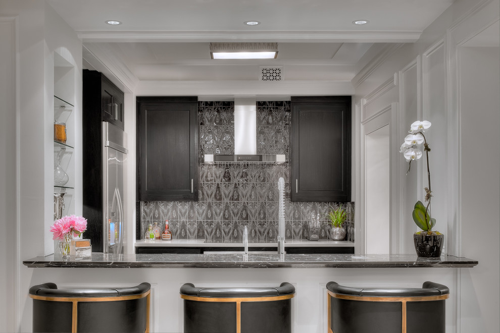 Inspiration for a small transitional galley kitchen in Houston with shaker cabinets, dark wood cabinets, metallic splashback and stainless steel appliances.