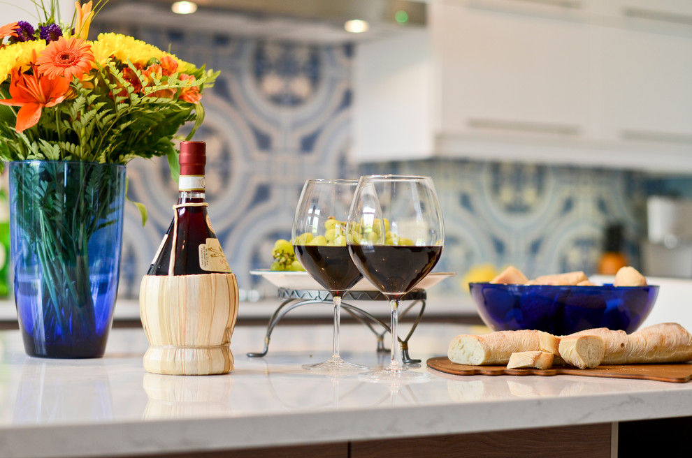 Example of a mid-sized minimalist l-shaped cork floor eat-in kitchen design in Ottawa with an undermount sink, flat-panel cabinets, white cabinets, quartzite countertops, blue backsplash, porcelain backsplash, stainless steel appliances and an island