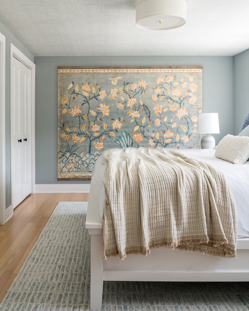 Inspiration for a large transitional master bedroom in Chicago with blue walls, medium hardwood floors, brown floor and wallpaper.