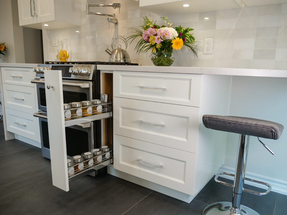 Small transitional eat-in kitchen in Toronto with a single-bowl sink, shaker cabinets, white cabinets, quartz benchtops, white splashback, marble splashback, stainless steel appliances, porcelain floors, no island, black floor and white benchtop.