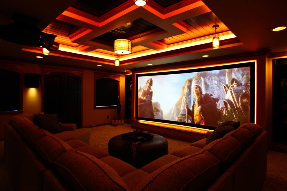 This is an example of a mid-sized traditional enclosed home theatre in Grand Rapids with carpet and a projector screen.