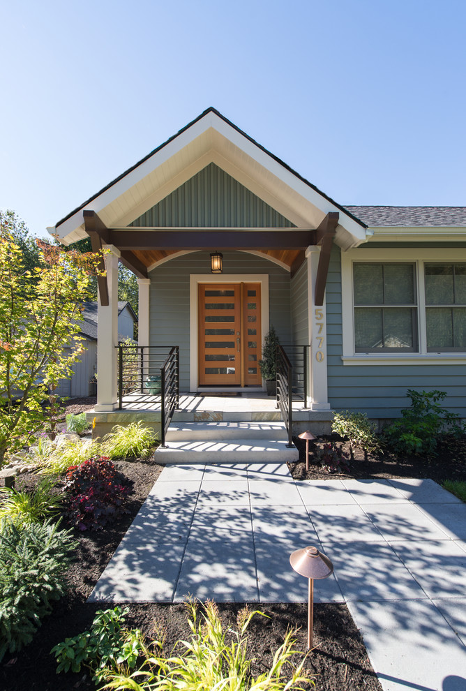 This is an example of an eclectic one-storey blue exterior in Portland with wood siding.