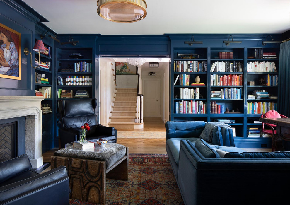 This is an example of a large traditional home office in San Francisco with medium hardwood floors, a library, a standard fireplace, a concrete fireplace surround, beige floor, blue walls and coffered.