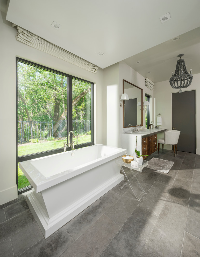 Design ideas for a large contemporary master bathroom in Salt Lake City with recessed-panel cabinets, medium wood cabinets, a freestanding tub, an open shower, gray tile, ceramic tile, white walls, ceramic floors, an undermount sink and marble benchtops.