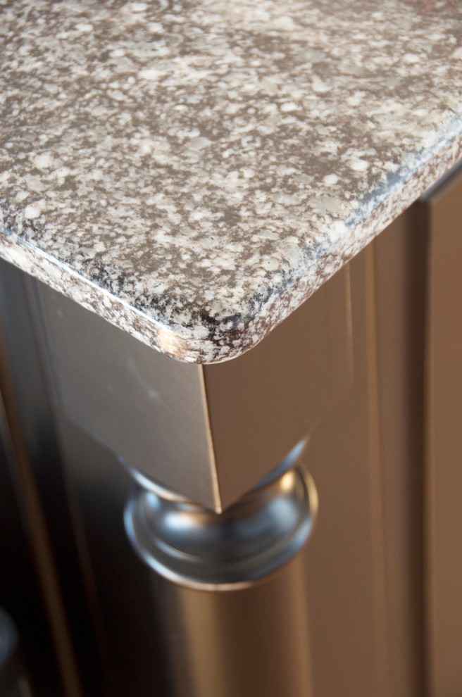 Inspiration for a mid-sized transitional u-shaped medium tone wood floor kitchen remodel with an undermount sink, flat-panel cabinets, white cabinets, granite countertops, gray backsplash, subway tile backsplash, white appliances and an island