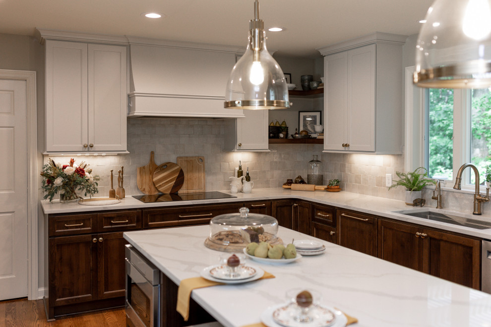 Inspiration for a mid-sized transitional l-shaped medium tone wood floor and brown floor eat-in kitchen remodel with an undermount sink, medium tone wood cabinets, quartz countertops, beige backsplash, terra-cotta backsplash, stainless steel appliances, an island, white countertops and recessed-panel cabinets