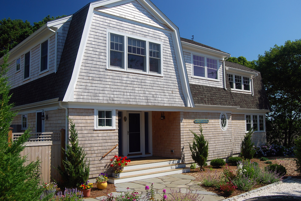 Inspiration for a mid-sized beach style two-storey exterior in Boston with wood siding and a gambrel roof.