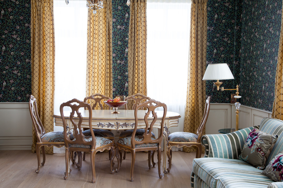 This is an example of a transitional open plan dining in Moscow with green walls, light hardwood floors and beige floor.