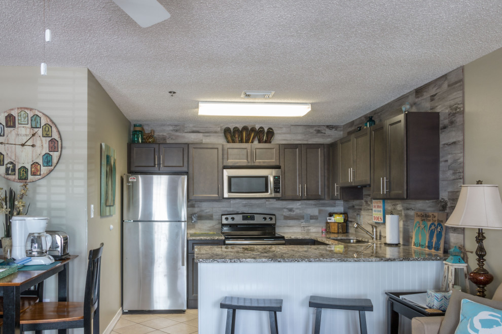 Eat-in kitchen - small rustic u-shaped cement tile floor and beige floor eat-in kitchen idea with an undermount sink, flat-panel cabinets, medium tone wood cabinets, granite countertops, gray backsplash, ceramic backsplash, stainless steel appliances, a peninsula and gray countertops