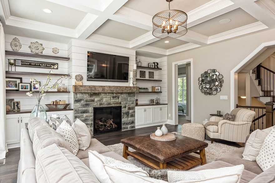 Living room - mid-sized farmhouse enclosed dark wood floor and brown floor living room idea in Columbus with beige walls, a standard fireplace, a stone fireplace and a wall-mounted tv