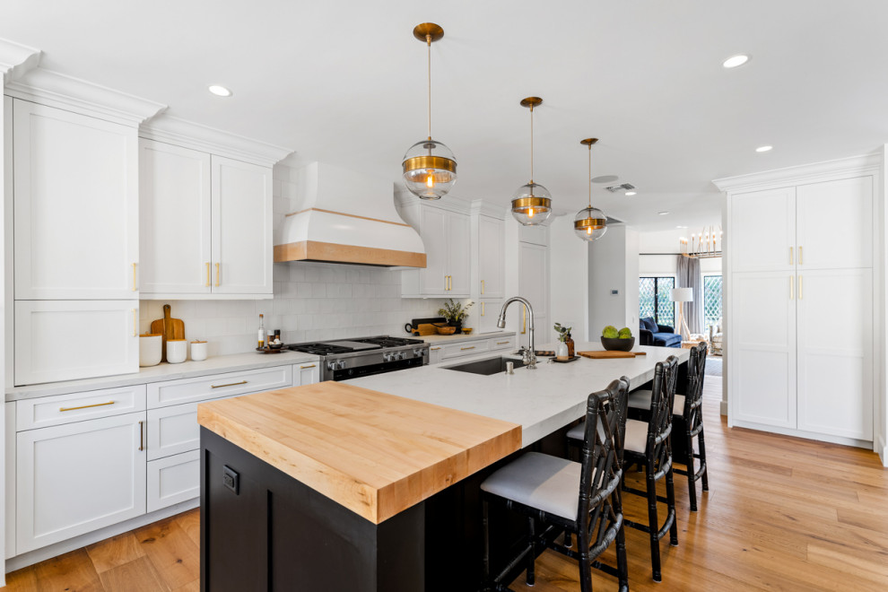 Kitchen - huge transitional light wood floor and beige floor kitchen idea in Los Angeles with a single-bowl sink, shaker cabinets, quartz countertops, white backsplash, ceramic backsplash, stainless steel appliances, an island and white countertops