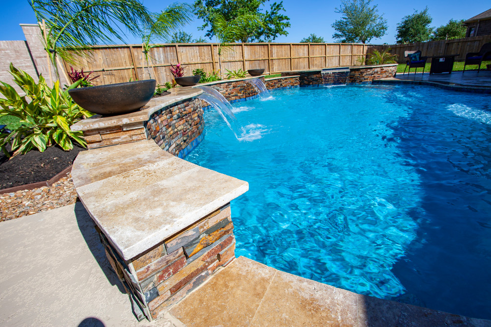 Design ideas for a mid-sized traditional backyard custom-shaped pool in Houston with decking.