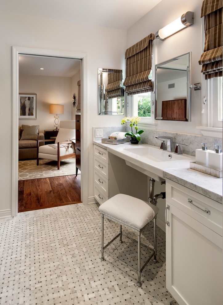This is an example of a mid-sized transitional bathroom in Los Angeles with shaker cabinets, white cabinets, grey walls, mosaic tile floors, a wall-mount sink, a one-piece toilet, gray tile, stone tile, marble benchtops and grey benchtops.